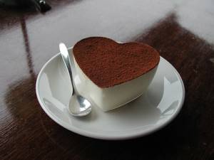 Illustration of a heart-shaped cup and saucer filled with cocoa