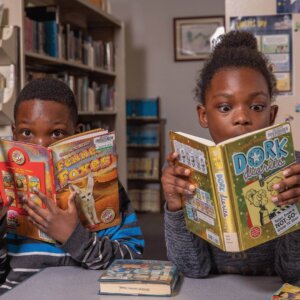 Kids reading different books in a library