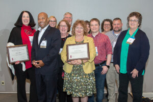 Pennsylvania Library Association Names Martin Library as Library of the Year The York County Library is the First in Pennsylvania to Receive the Statewide Award YORK, PA – The Pennsylvania Library Association named Martin Library as “Library of the Year” Tuesday during the association’s annual conference. The York County library is the first in Pennsylvania to receive this statewide award. The designation comes on the heels of the library’s recent award as a PA Forward Gold Star Library. "Martin Library has real energy. It has tremendous passion. It moves quickly on initiatives, is nimble, creative and always inclined to find a way to make things happen,” says York County Libraries President Robert F. Lambert. “I applaud the staff for this well-deserved recognition! The people of the City of York are fortunate to have this excellent library at their fingertips and the County is lucky to have it as a model and inspiration for our Commonwealth. BRAVO!" Each year, the Pennsylvania Library Association recognizes members who have contributed significantly to the library profession and the betterment of libraries in Pennsylvania. This year, the 2018 Awards Committee opened nominations for the new “Library of the Year Award.” Entries came in from across the state. The association’s newest award honors a library that exhibits excellence in serving its community, advancing staff development, and leadership. “As the Director of Martin Library, I am so proud of the accomplishments achieved by our talented and visionary staff,” says Martin Library Director Mina Edmondson. “Martin Library’s staff identify the diverse needs of our community, build effective partnerships and create innovative solutions to address those needs. We thank the Pennsylvania Library Association for this recognition of the work we do every day in the City of York.” Among the library’s many accomplishments is its ever-evolving and diverse partnerships with community agencies, public and private schools, early childhood education centers, area hospitals and the county prison. Martin's longest-standing partnership is the School Library Aides at Martin (SLAM) program. For 31 years, SLAM has placed highly trained staff into the libraries of the School District of the City of York, making it possible for students to receive library services. Martin Library also delivers the district’s afterschool program providing learning enrichment, learning support, special activities and meals to more than 800 children, five days a week during the school year. This year, students will learn coding, a vital 21st century skill set through library staff. In 2017, Martin Library opened the award-winning Salem Square Library. The Salem Square neighborhood is challenged by poverty, unemployment, illiteracy, and crime. Martin Library provides workforce development, job search assistance, afterschool STEAM programming, early childhood educational programming and public technology access in the heart of the neighborhood. The library has a long history of bridging the digital divide by bringing new technology, assistance and training to community members. Its Tech Guru regularly visits all York County Libraries to help residents with their computers, tablets, and phones. In addition, Martin Library is an integral player across the city in supporting makerspaces, including robotics and coding for all members of the community. Martin Library is a branch of York County Libraries. It is located at 159 E. Market Street in the city of York and has been transforming lives and building communities since 1935. ### Caption Martin Library Director Mina Edmondson proudly accepted the “Library of the Year Award” on behalf of the entire Martin Library staff at the Pennsylvania Library Association Annual Conference in Harrisburg. This is the inaugural year for the award, making Martin Library the first library in Pennsylvania to receive this honor. Taking a moment following the award ceremony is, left to right, Pennsylvania Library Association 2018 Awards Committee Chair Janis Stubbs, Pennsylvania Library Association Executive Director Christi Buker and Martin Library Director Mina Edmondson.