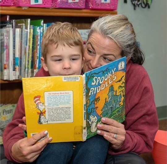 Woman And Child Reading A Children’s Book Together At Hufnagel Library