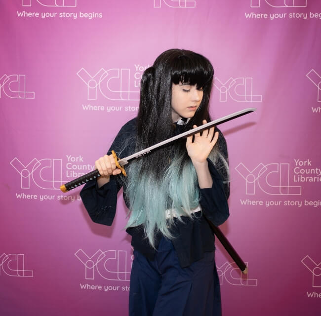 Girl In Wig And Hakama Posing With A Prop Sword