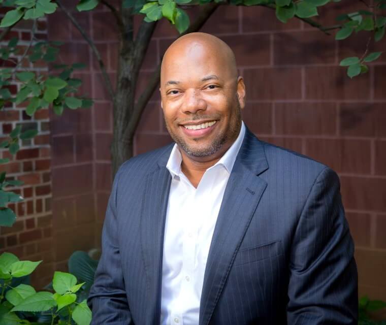 President Robert Lambert Headshot In Courtyard