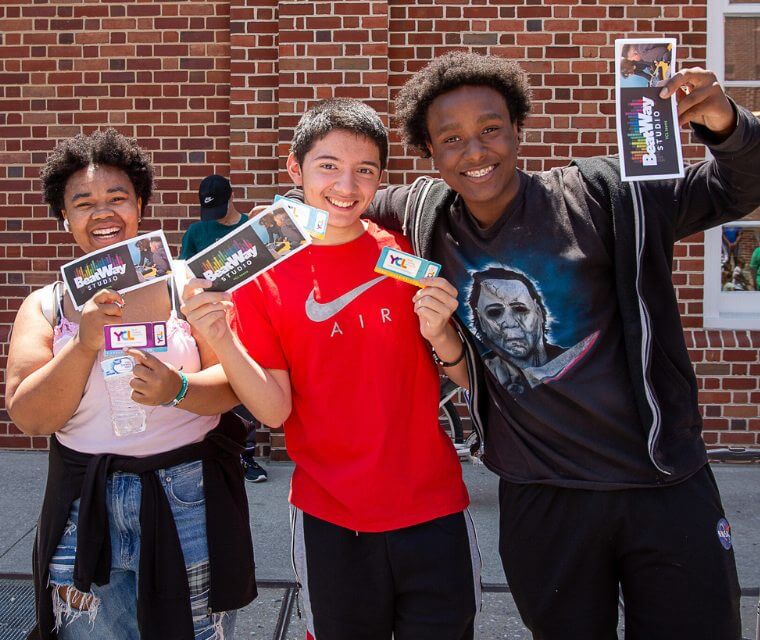 Three Smiling Teens Holding Beatway Studio Brochure