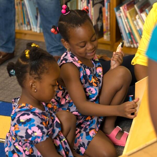 girls playing together at dollhouse
