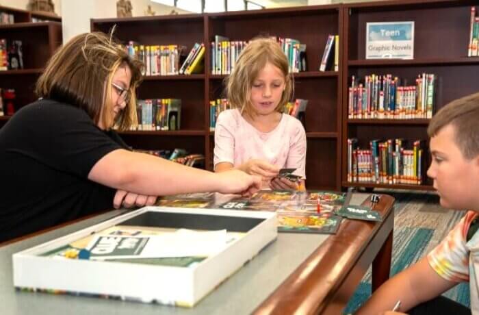 Teen And Kids Playing Game Clue