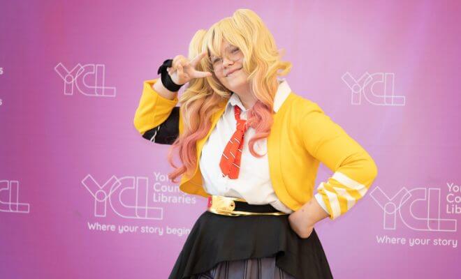 Teen Dressed In Anime Cosplay Making Peace Sign