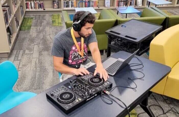 Teen Wearing Headphones Using Dj Equipment