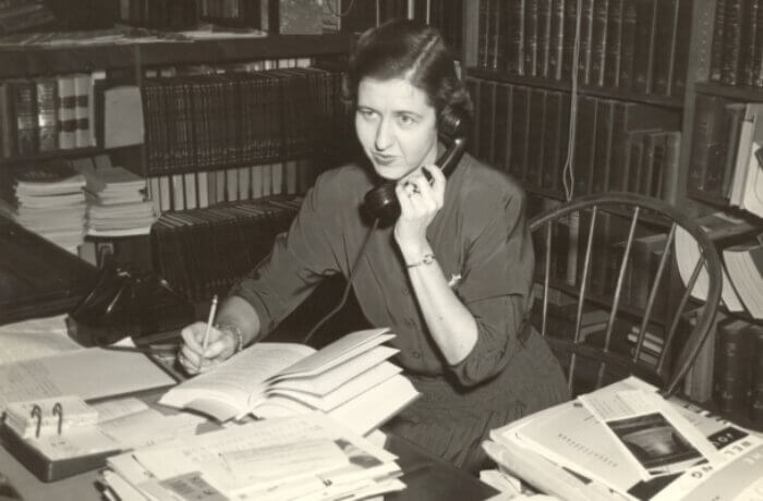 Black and white photo of a Martin Library worker from the 1950s. She is seated at a desk and taking a phone call.