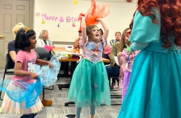 birthday girl jumping at party with mermaid princess