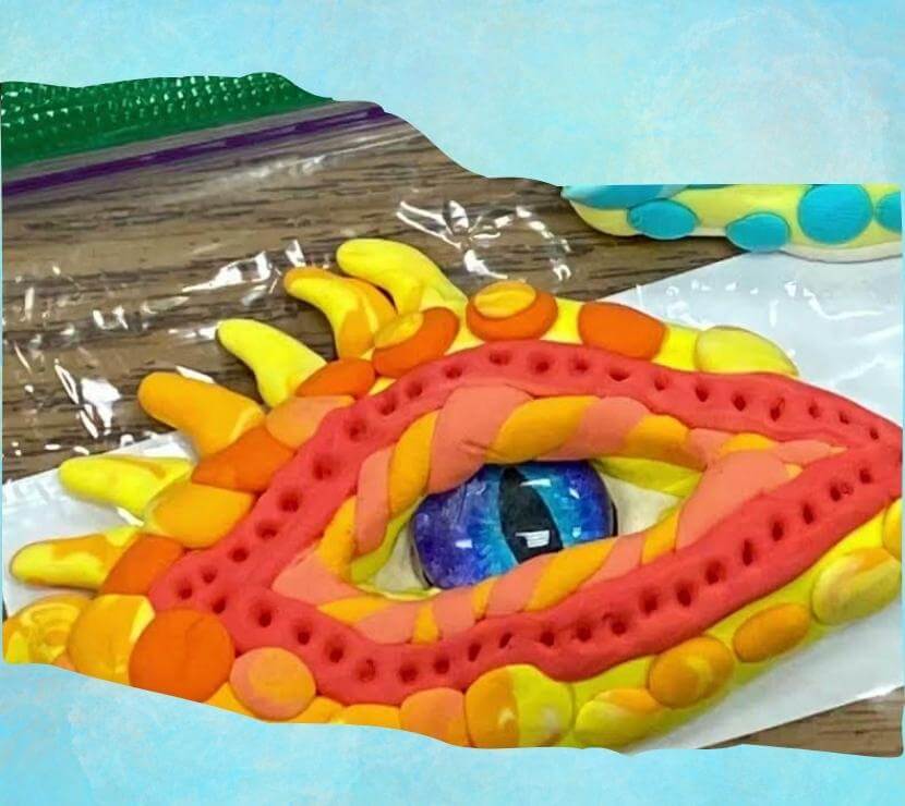 A picture of a finished library craft - a dinosaur eye made from clay
