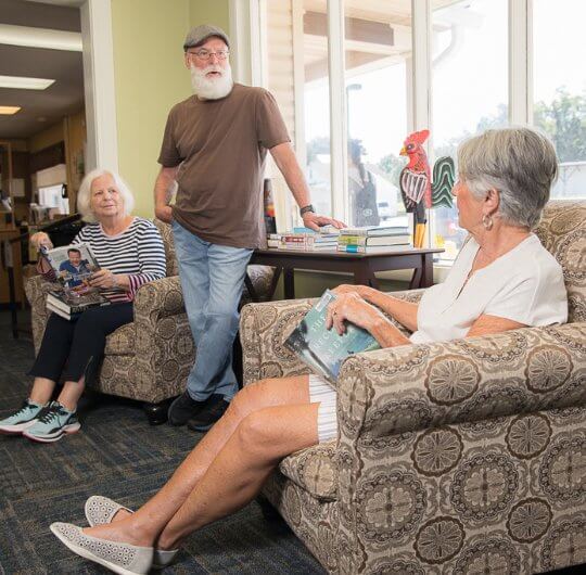 group of senior adults talking at the library