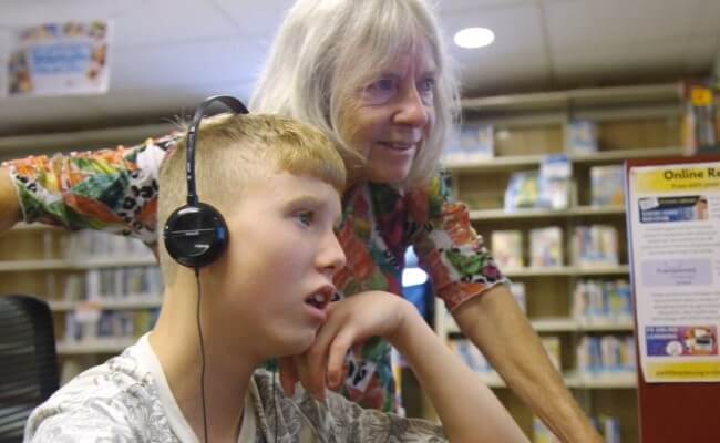 library member and grandson use computer together collinsville library