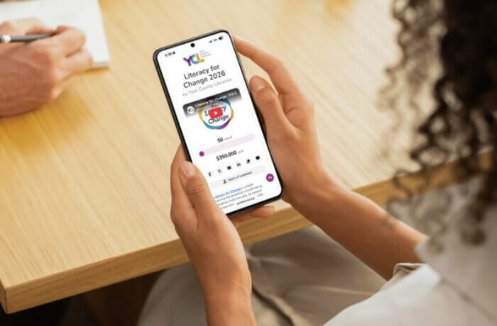 woman-holding-phone-signing-up-as-library-champion