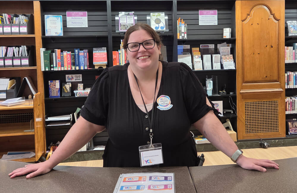 Staff member smiling at Martin Library main desk