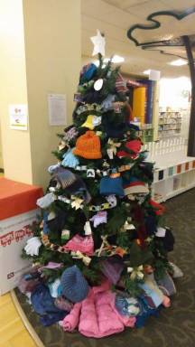 Photo of Warming Tree with gloves, hats, scarves, coats.